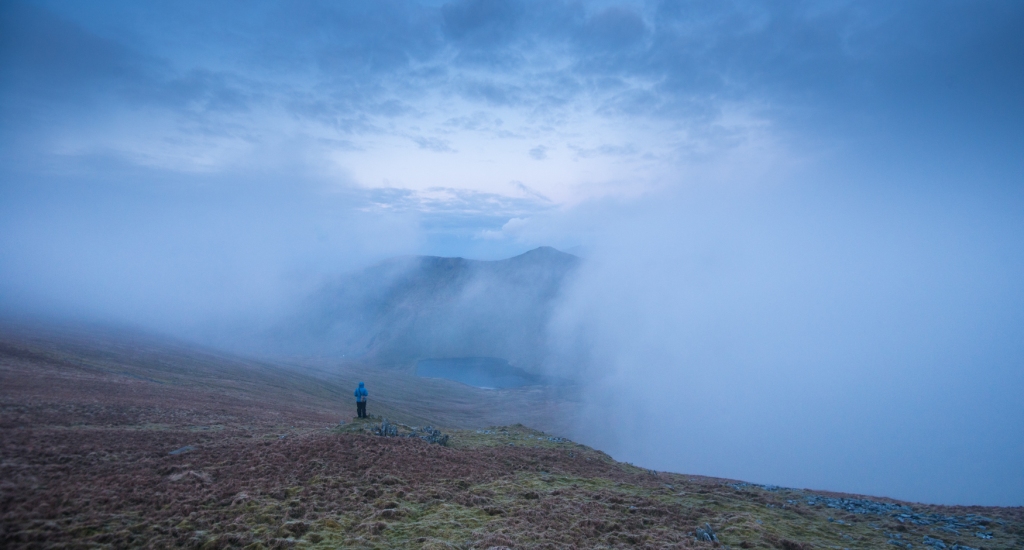 Making notes from below Harter Fell as the cloud swirls to reveal Kentmere Reservoir