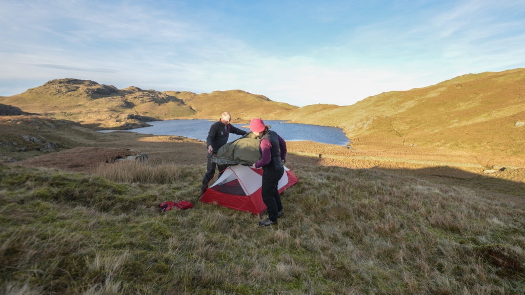 Putting up the tent on the 60 degree line near Angle Tarn