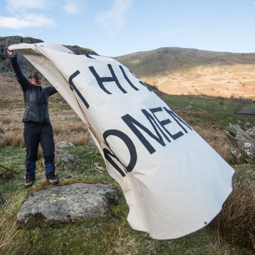 Harriet folding away the cloth at the end of the installation