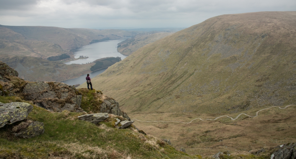 Harriet making notes from a crag with Artlecrag summit and Haweswater beyond