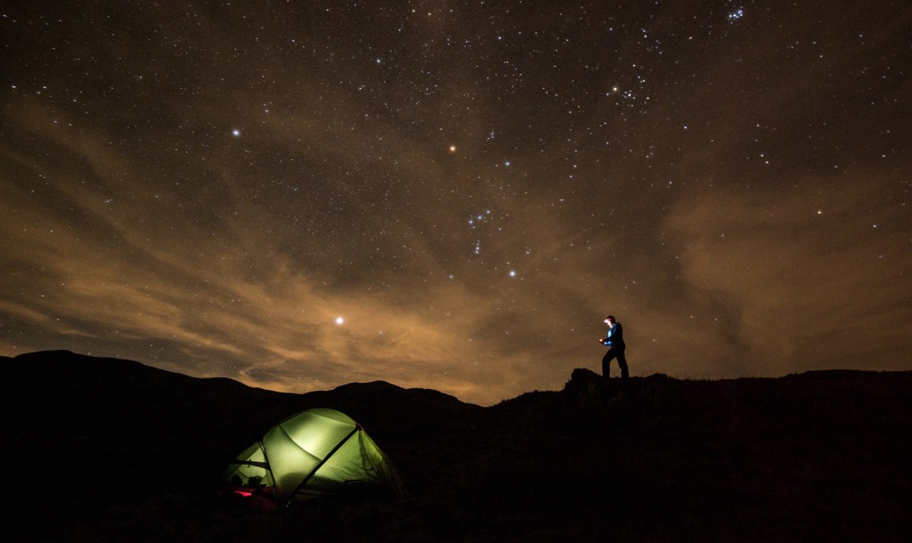 Making notes outside the tent after dark
